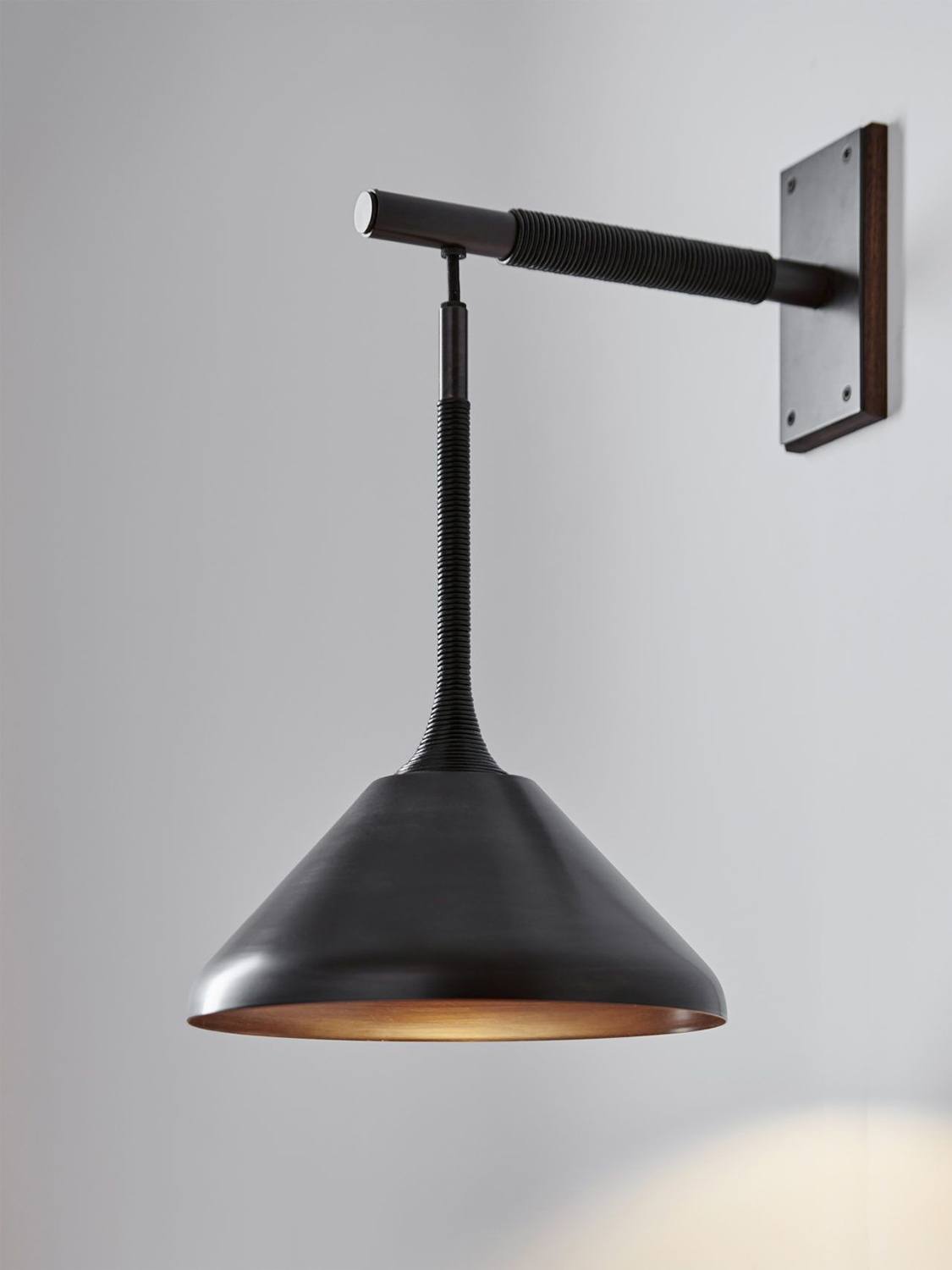 Pelle’s Stem Shade Sconce in black brass with black leather coiling.