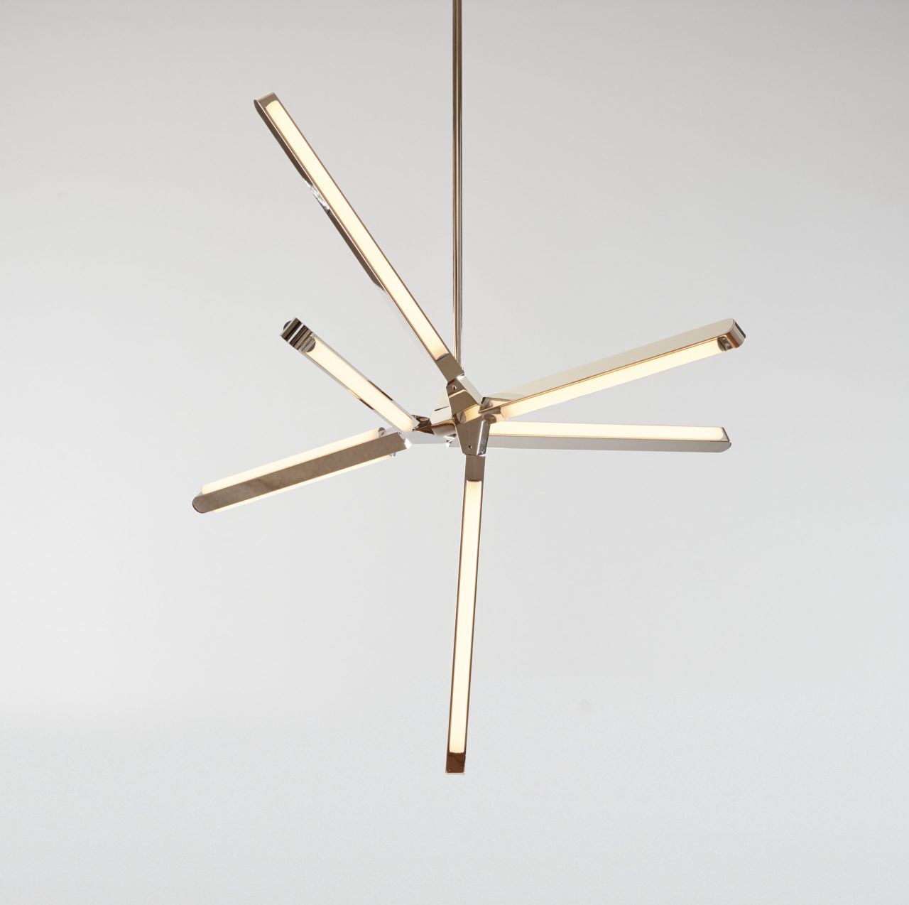 Front view of an illuminated Pris Crystal fixture with reflective polished nickel metal components.