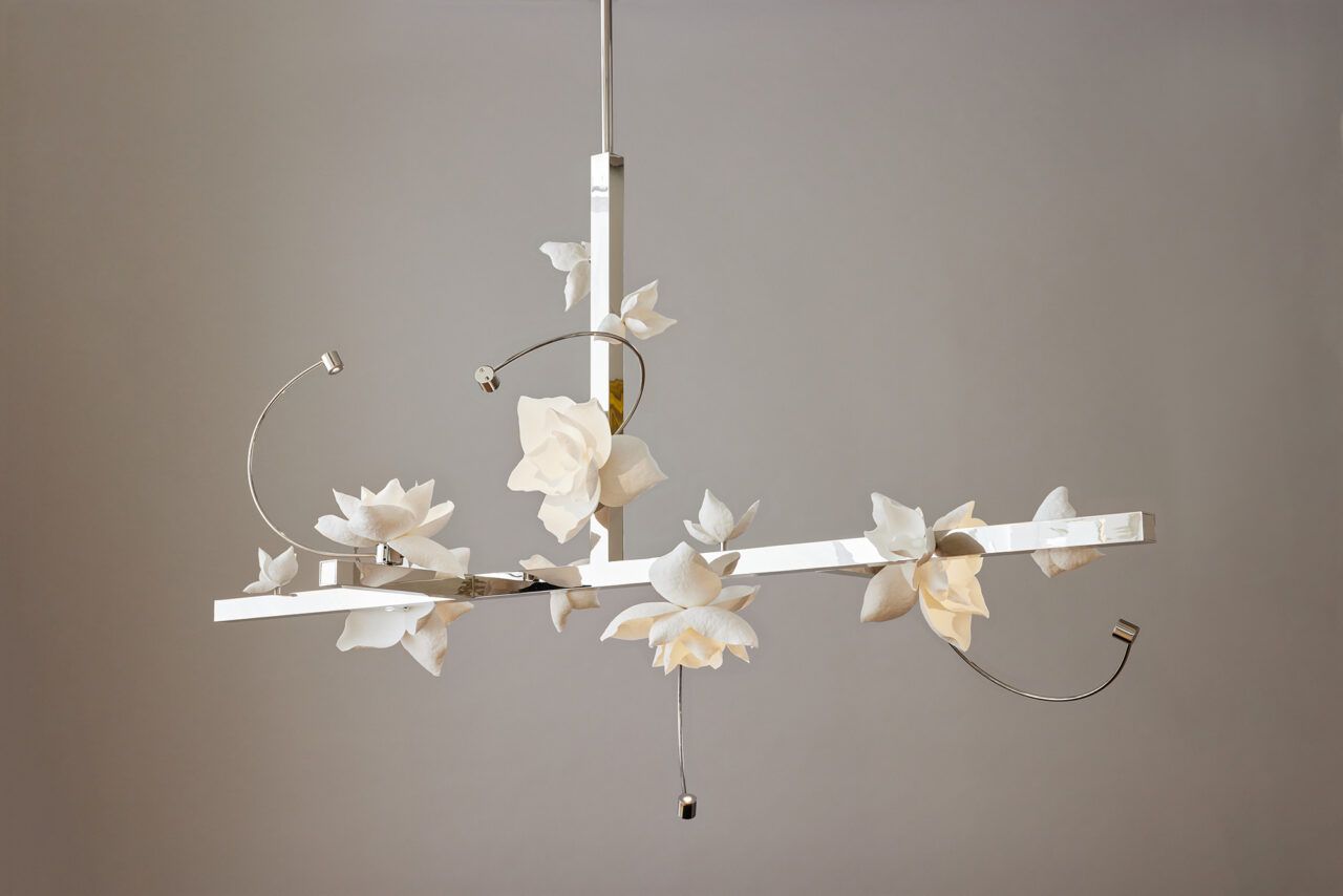 A custom Lure Chandelier T, with five large white flowers and a polished nickel structure.