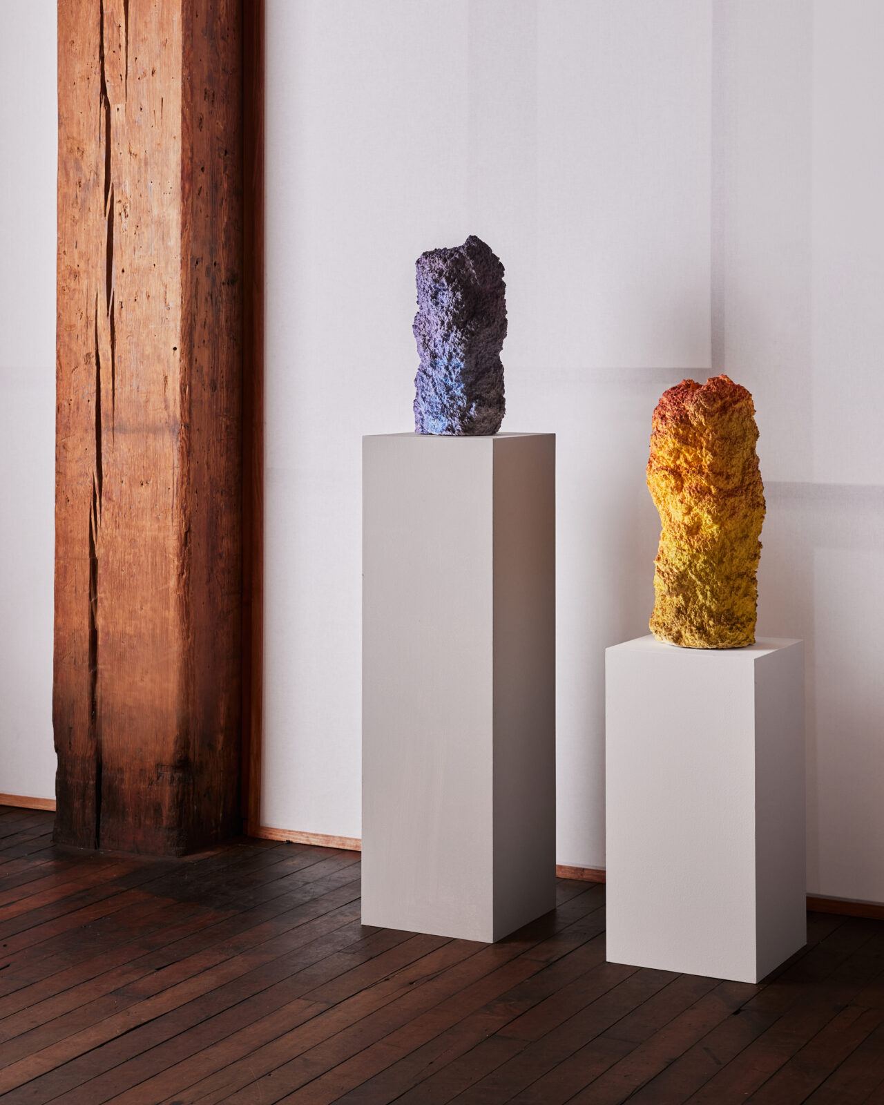 A pair of Moss Vessels, one in cool purple tones and one in warm orange tones, are displayed in Pelle’s showroom.