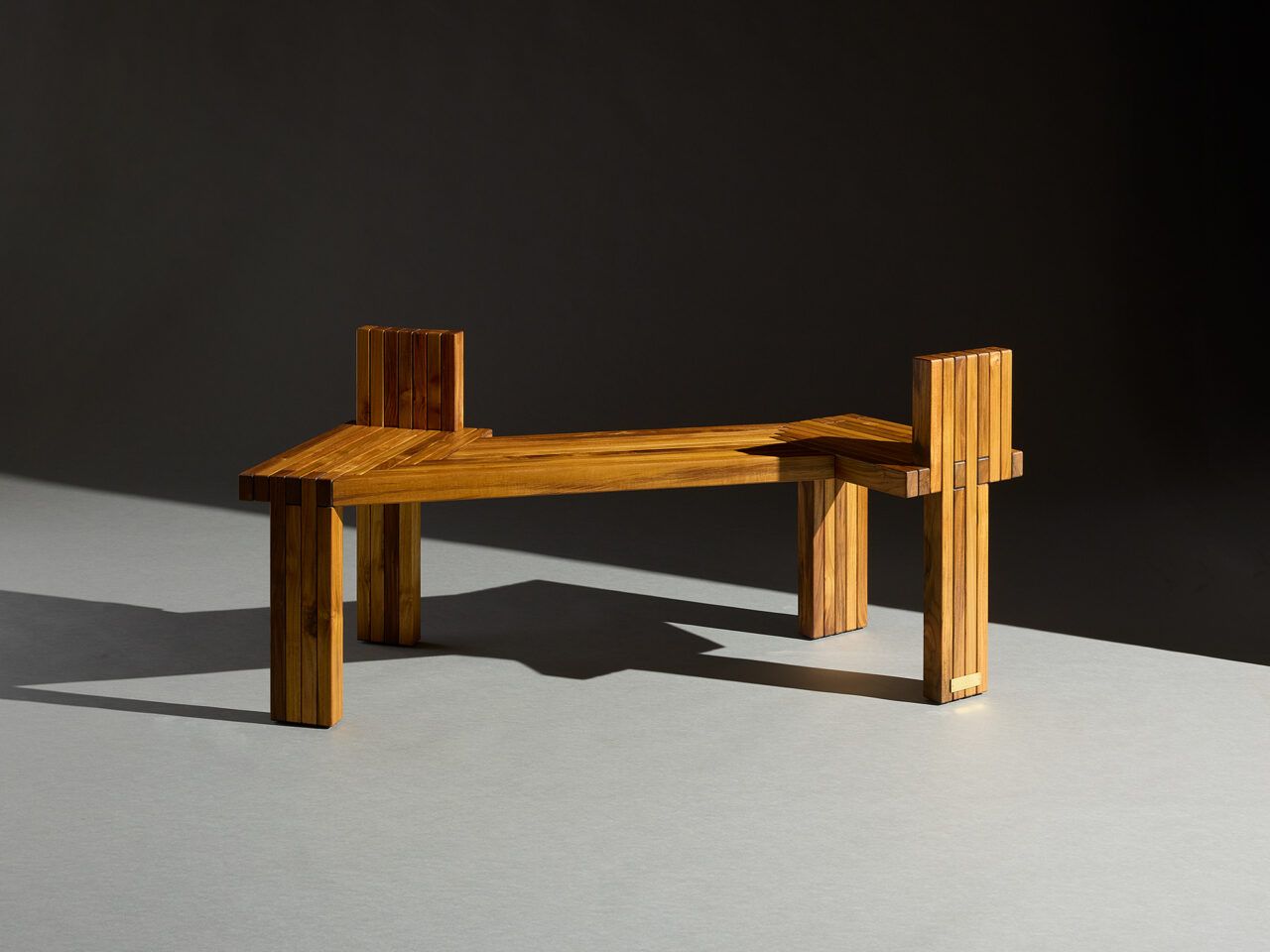 Sculptural bench made of dimensional teak
